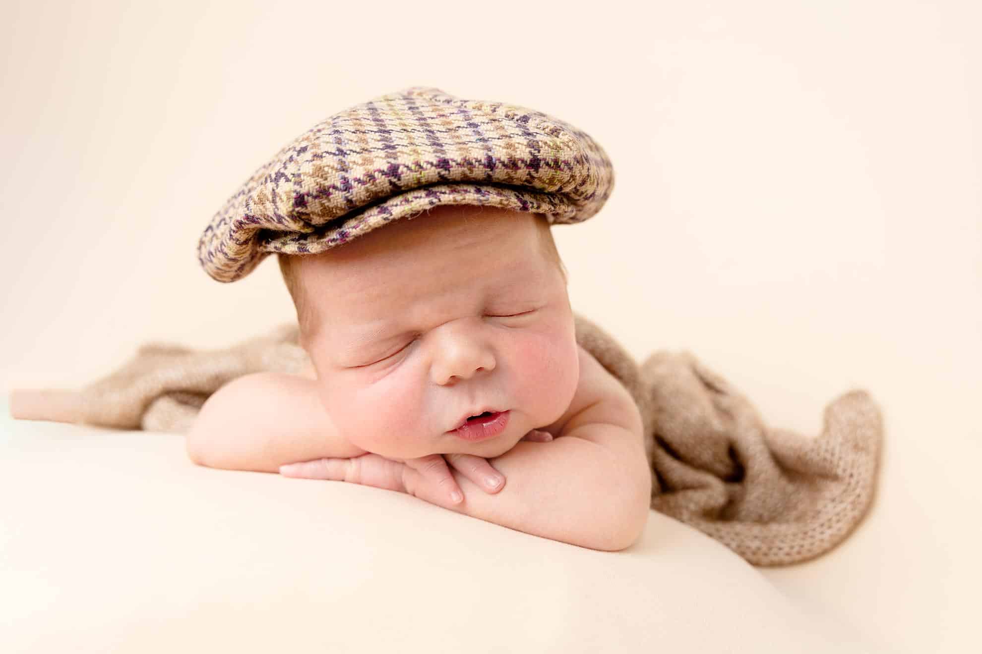 baby in flat hat